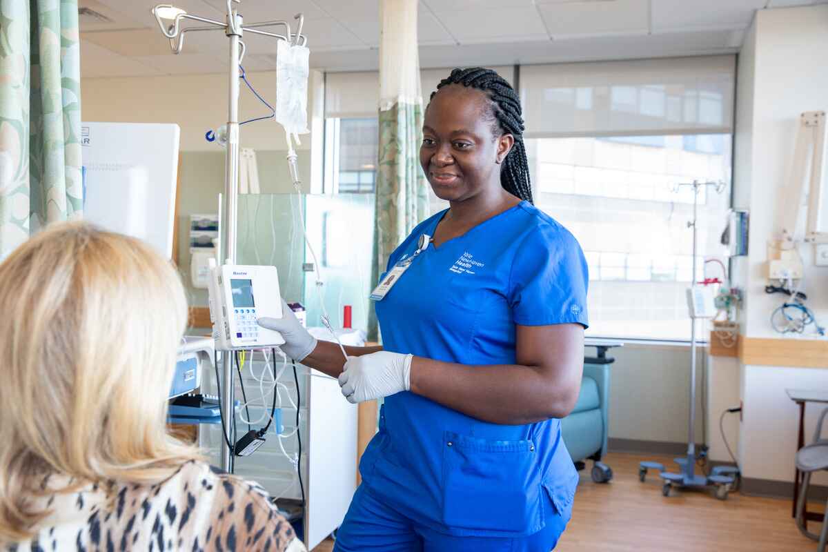 An oncology nurse prepares a patient for chemotherapy