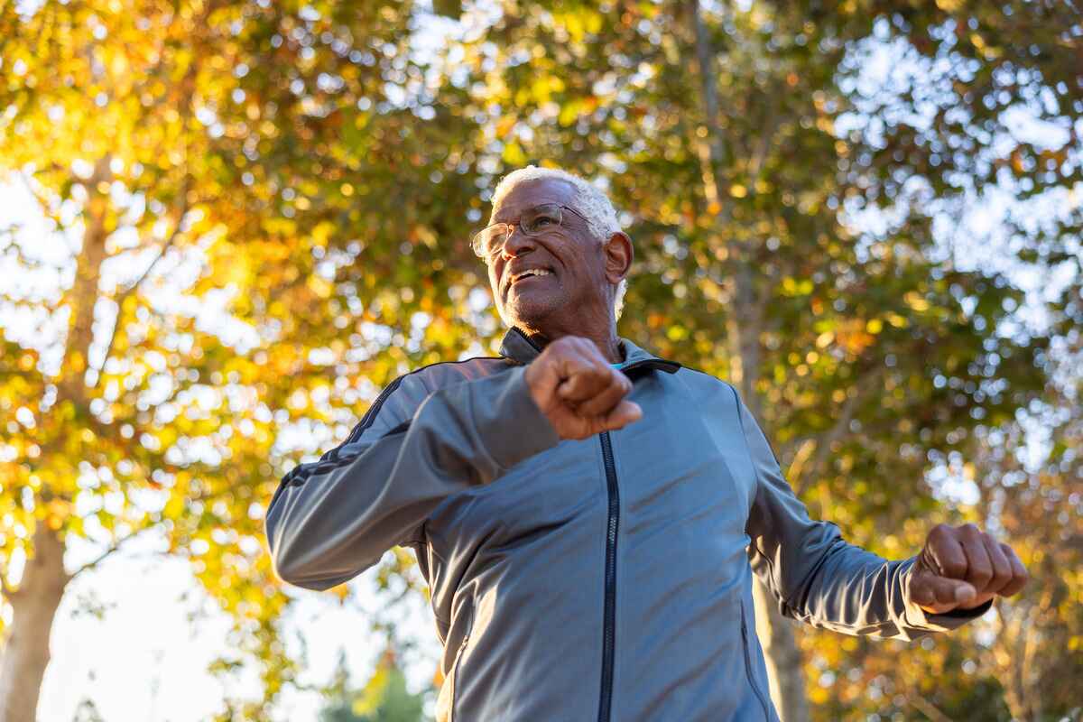 Elderly man exercises outside