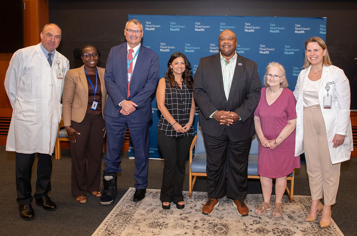 Thomas Balcezak, MD, YNHHS chief clinical officer; Nana Boahemaa, RN, associate director, nursing, Home Hospital; Christopher O’Connor, YNHHS CEO; former patients Melissa Desmond, the Rev. William McCullough and Ann Daly; and Carly Brown, MD, medical director, Home Hospital.